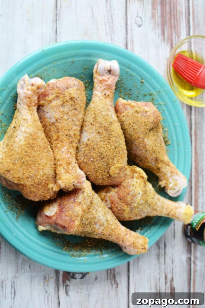 Smoky Grilled Chicken Drumsticks 4 Chicken drumsticks cooking on a hot grill with visible grill marks