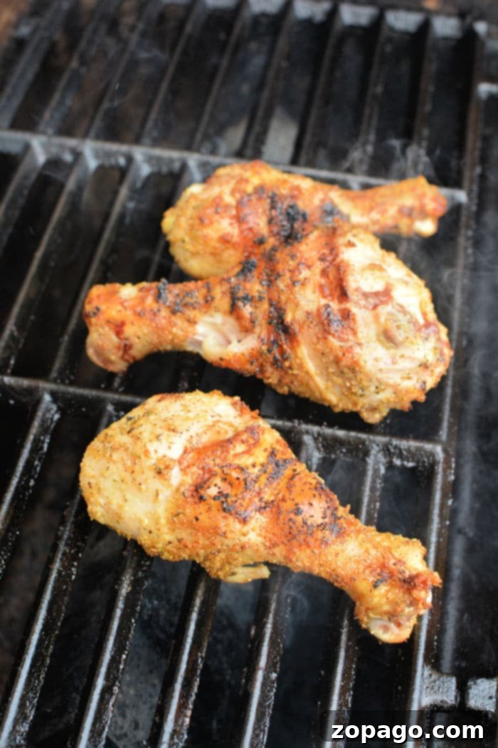 Smoky Grilled Chicken Drumsticks 6 Chicken drumsticks arranged on a grill ready for cooking