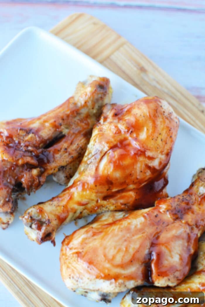 Crispy Oven Butterfly Chicken 6 Perfectly oven baked butterflied chicken legs glazed with barbecue sauce on a baking sheet.