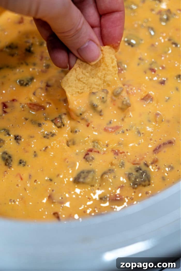 Velveeta Sausage Dip Rotel, a creamy and spicy hot dip perfect for parties, served with tortilla chips
