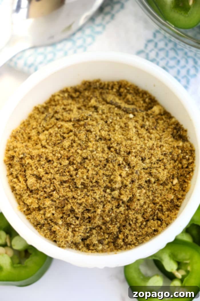 Make Your Own Fiery Jalapeno Powder 7 A close-up of a small glass jar filled with bright green jalapeno powder, labeled 'Homemade Jalapeno Powder' to emphasize its pure and fiery nature.