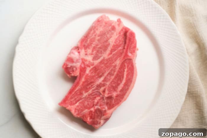 Pan-Seared Lamb Shoulder Chops: A Simple Guide 7 Perfectly cooked lamb shoulder chops resting in an air fryer, showcasing their crispy exterior and promising a juicy interior.