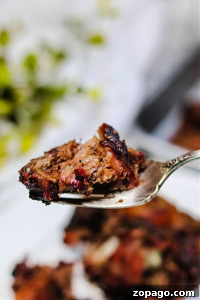 Fall-Off-The-Bone Traeger Smoked Oxtail 7 Delicious grilled oxtail, served with a savory sauce, ready for a comforting meal.