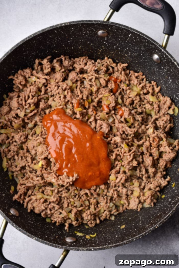 Ultimate Sloppy Joe Sliders 4 Ground beef Sloppy Joe Sauce sizzling in a skillet, ready for mixing.