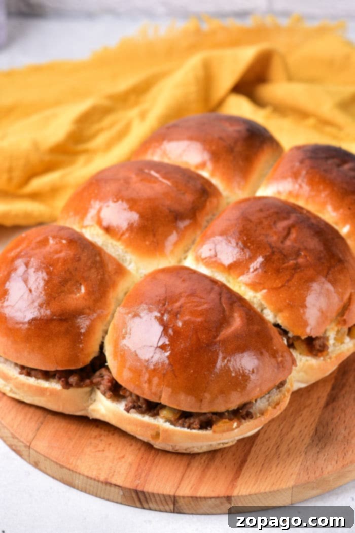 Saucy Mini Sloppy Joes 5 A perfectly assembled Sloppy Joe Sandwich, with hearty meat filling overflowing from a toasted bun.