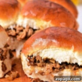 Sloppy Joe sliders on a wooden board, with toasted buns hugging the savory Sloppy Joe meat filling.