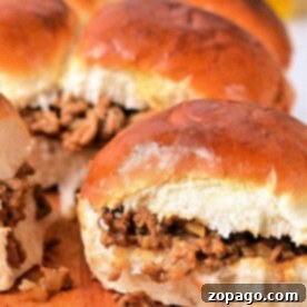 Sloppy Joe sliders on a wooden board, with toasted buns hugging the savory Sloppy Joe meat filling.