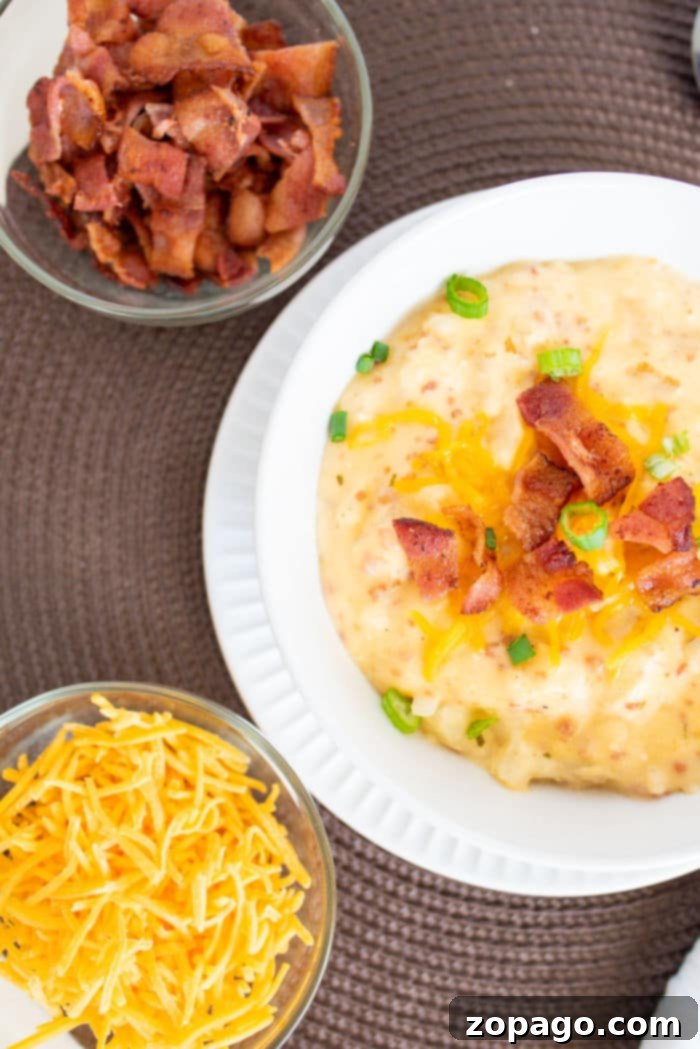 Golden Hashbrown Potato Soup 4 A beautifully presented bowl of loaded potato soup, adorned with a generous amount of crispy bacon, shredded cheese, and fresh green onions. Extra bowls of toppings are ready for serving.