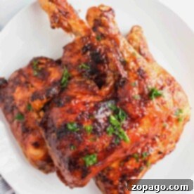 Perfect Chicken Leg Quarters 7 Grilled chicken quarters, expertly prepared from how to cook chicken leg quarters guides, are beautifully garnished with herbs on a white plate.