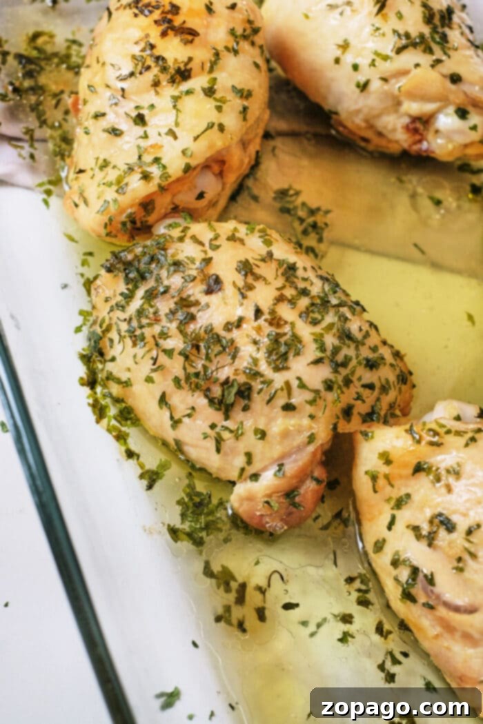 Perfectly Cooked Chicken Thighs: Your Guide 7 Boiled chicken thighs with herbs and garlic in a glass dish, offering a flavorful alternative for those wondering how long to boil chicken thighs.