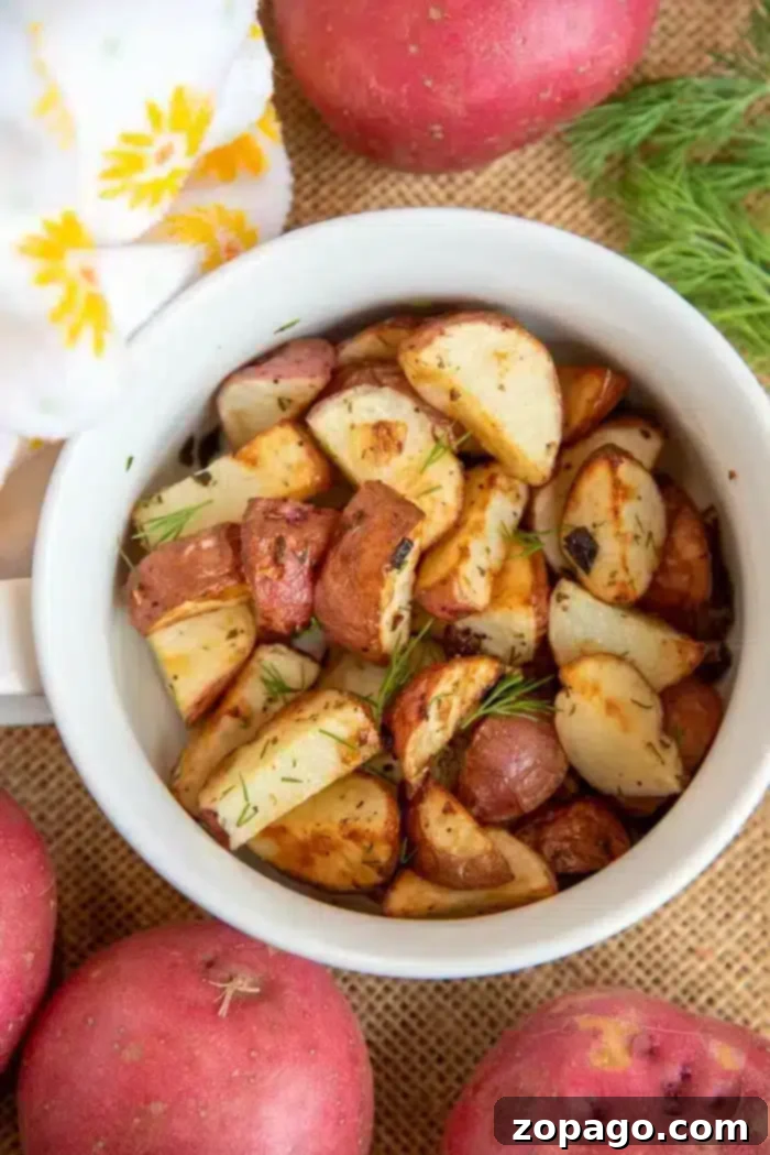 Crispy Air Fryer Baby Potatoes 6 A vibrant bowl of cooked baby potatoes, garnished with fresh herbs, ready to be enjoyed.