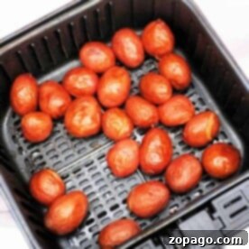 Freshly cooked baby red potatoes, nestled in a black air fryer basket, offer a delightful twist on your favorite baby potatoes recipe.