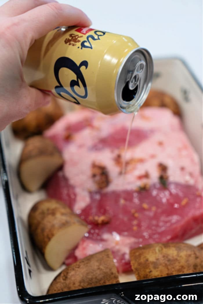 Perfectly Tender Oven Corned Beef 5 A corned beef brisket, cooked to perfection, glistening with a mustard glaze in a roasting pan, fresh out of the oven. The meat looks incredibly tender, and the glaze is beautifully caramelized.