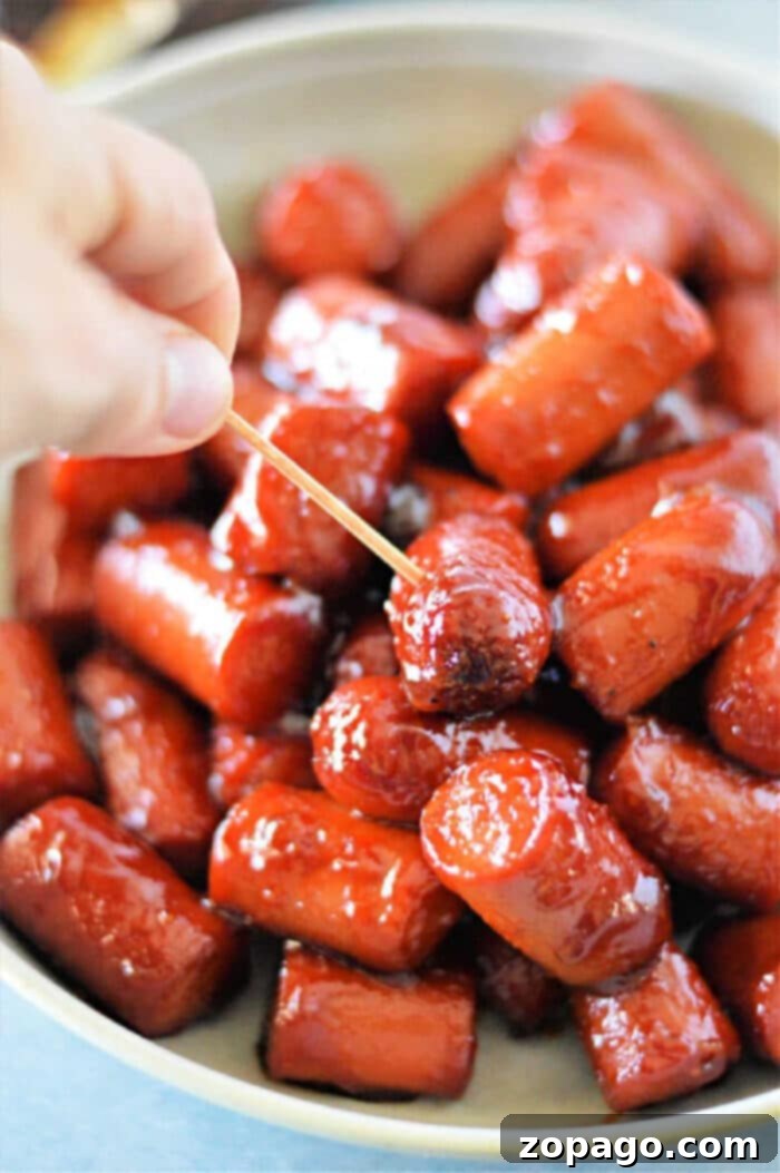 Irresistible Hot Dog Burnt Ends baking in the oven, glazed with a sticky BBQ sauce