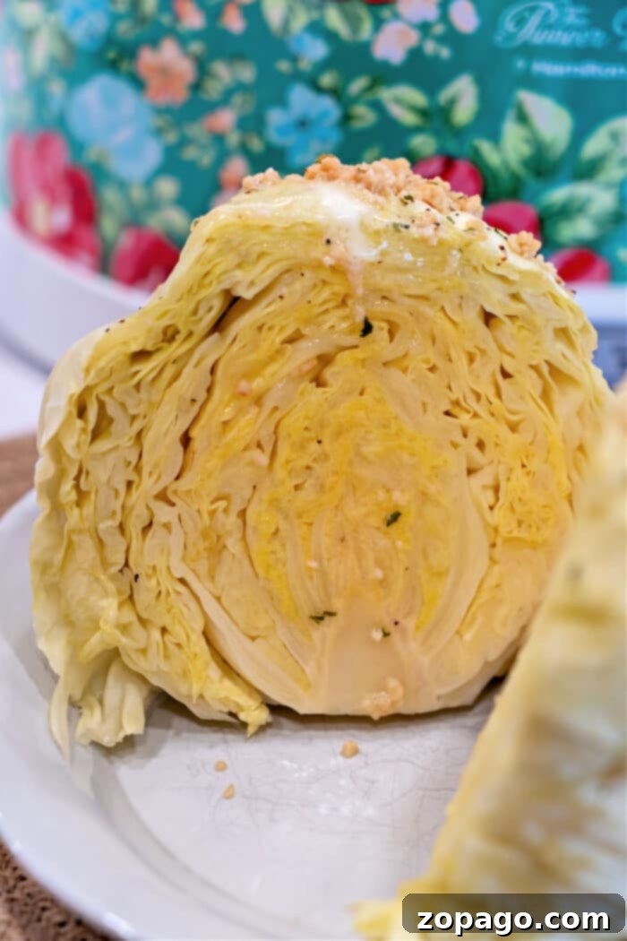 Slow Cooker Whole Cabbage 7 Close-up of perfectly sliced slow-cooked cabbage on a plate, showcasing its tender layers.