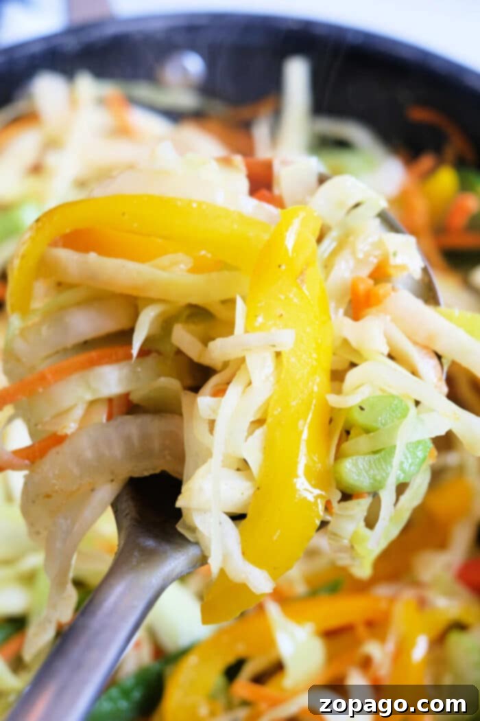 Island Braised Cabbage 6 A serving of Jamaican spicy cabbage recipe, with visible carrots and bell peppers, ready to eat