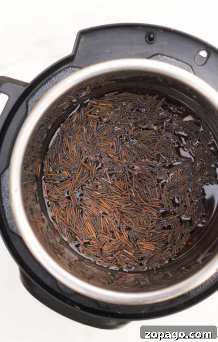 Fluffy, Non-Sticky Instant Pot Rice Every Time 5 Cooking black rice in an Instant Pot without sticking involves filling the pot with water and adjusting the settings for perfect results, showcasing its vibrant color.