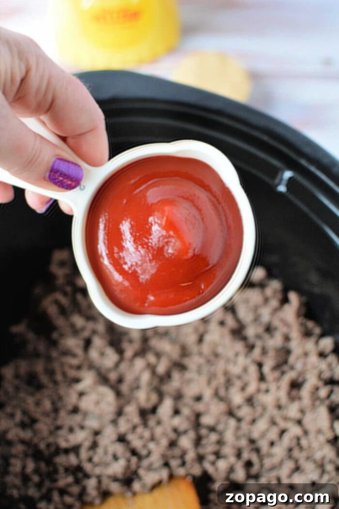 Effortless Slow Cooker Sloppy Joes 4 Close-up of Crock Pot Sloppy Joes simmering, showing rich, saucy ground beef.