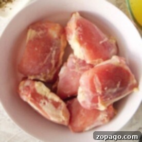 Frozen Chicken Shelf Life 8 A bowl with frozen raw chicken thighs rests on a light-colored surface. Remember, knowing how long frozen chicken is good for ensures safety and flavor.