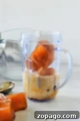 Coffee Frappe 5 Ice cubes, milk, and a hint of frozen coffee sit in a blender cup on the kitchen counter.