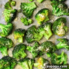Roasted broccoli florets with grated cheese, nestled on parchment paper, bake frozen to crispy perfection.