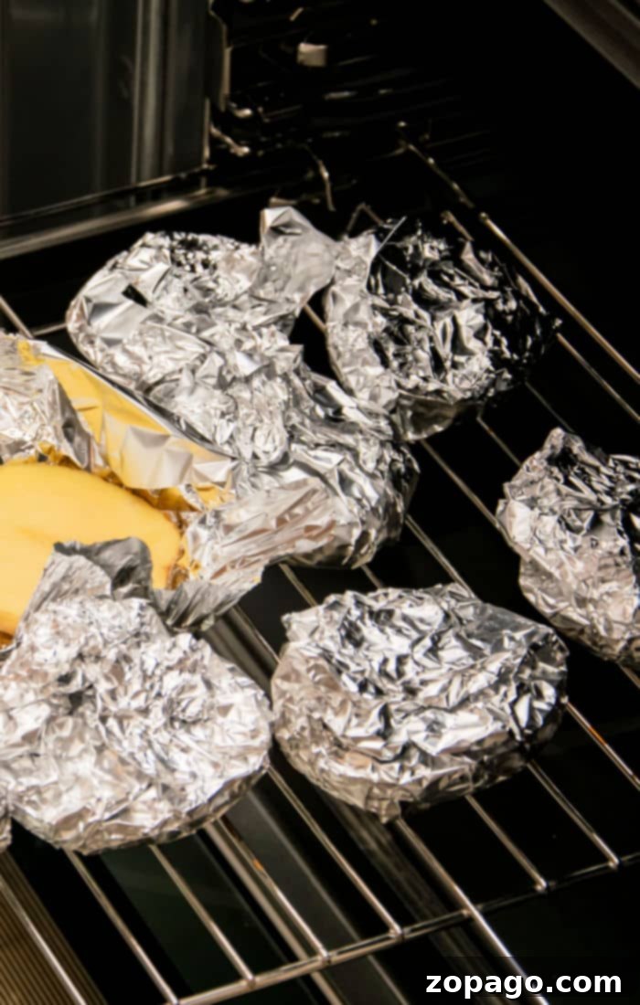 Foil-Wrapped Baked Potatoes 3 how long to bake potatoes at 375 in foil, showing six foil-wrapped potatoes