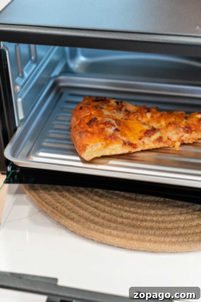 Reviving Cold Pizza in Your Toaster Oven 3 Reheating pizza in a toaster oven delivers crispy crust and gooey cheese