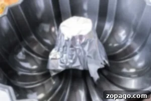 Perfect Chicken Cooking by the Pound 8 A bundt pan with a small metal cup covered in aluminum foil placed upside down at the center