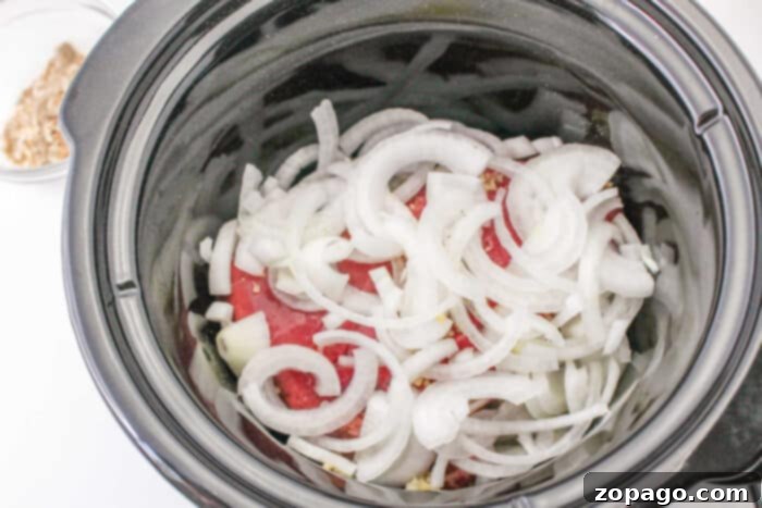 Effortless Slow Cooker Pot Roast 5 Sliced onions simmered with a splash of red wine in a slow cooker, alongside a bowl of chopped walnuts.