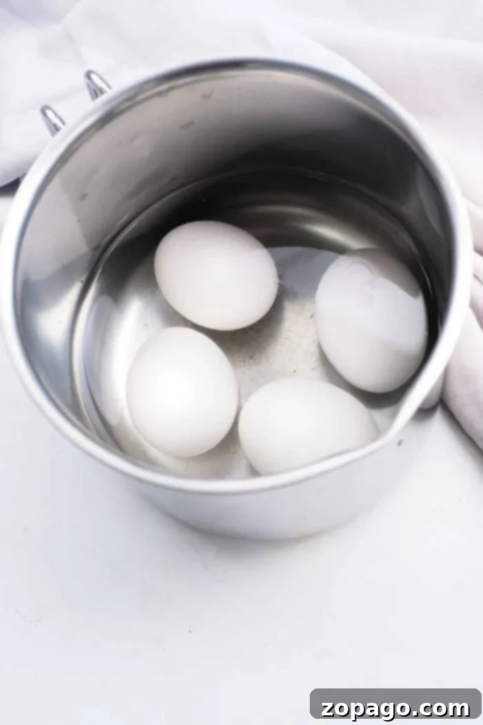 Mastering Soft Boiled Eggs 3 Soft Boiled Eggs from Boiling Water - Closeup of a soft-boiled egg being peeled, revealing a soft white.