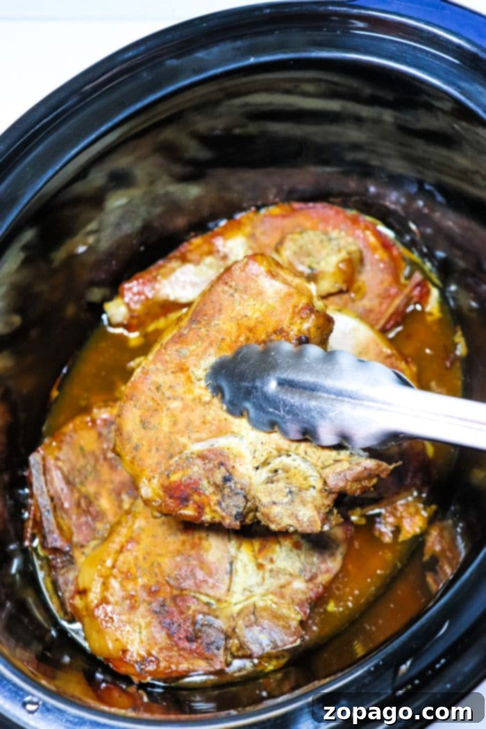 Optimal Cook Times for Bone-In Pork Chops 5 Slow cooker pork chops with a rich, brown gravy, accompanied by sliced mushrooms