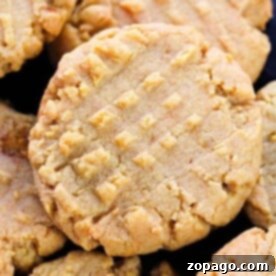 Close-up of peanut butter cookies with a crisscross fork pattern on top, perfectly baked to golden perfection. Wondering how long to bake cookies for that ideal texture? This delightful batch unveils the secret.