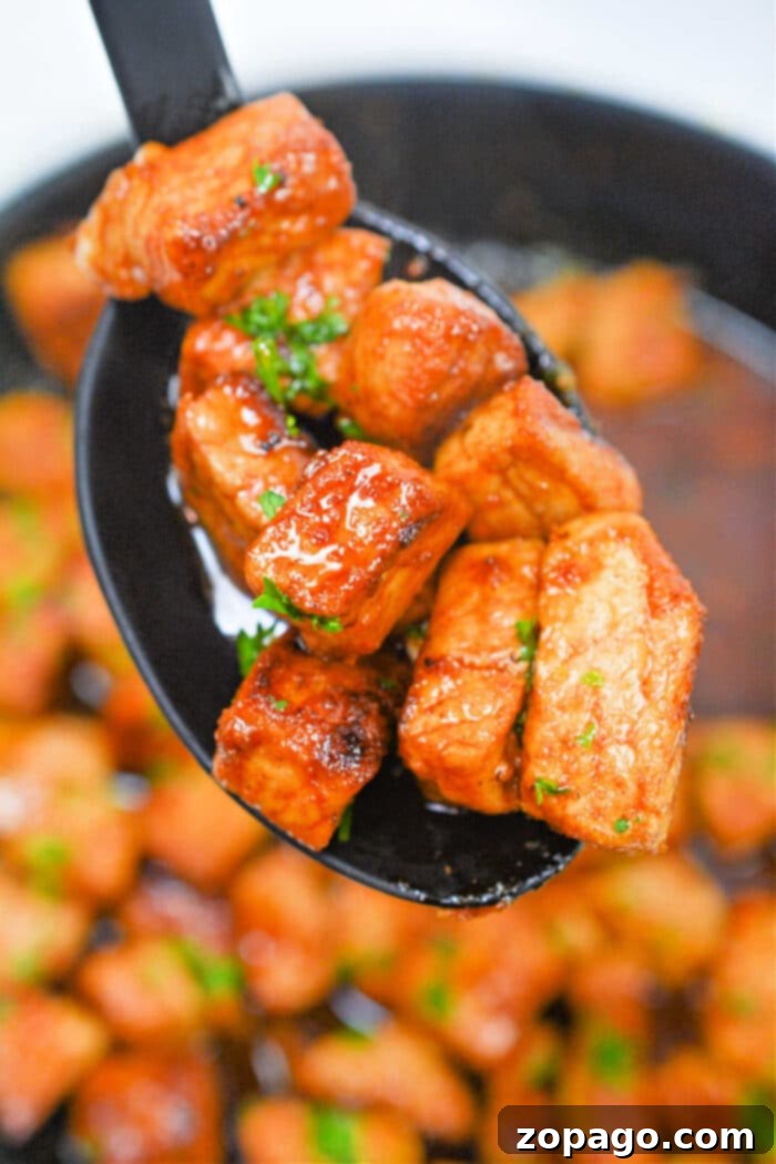 Crispy Pork Bites Perfection 6 Crispy Air Fryer Pork Bites served in a basket, garnished with fresh herbs.
