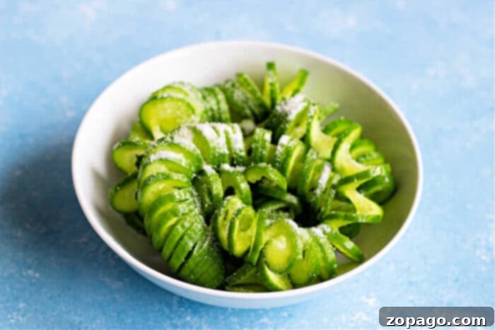 Oi Muchim 4 A close-up of spiral-cut cucumbers in a bowl, ready for dressing.