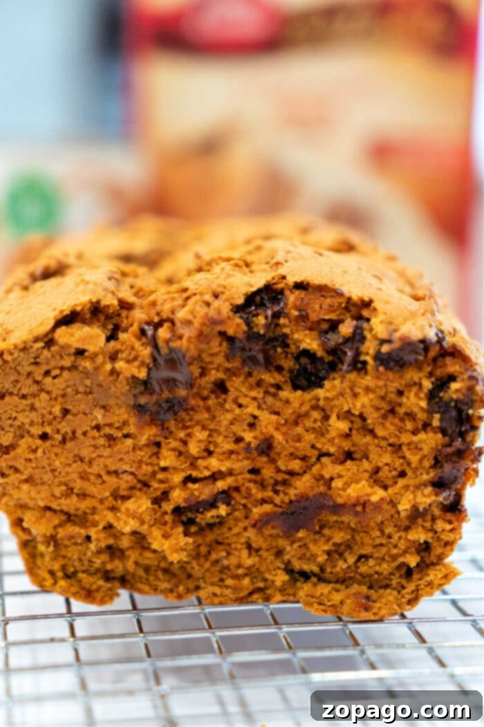 Spice Cake Mix Pumpkin Bread 2 Delicious Pumpkin Bread with Spice Cake Mix on a rustic board, ready to be sliced.