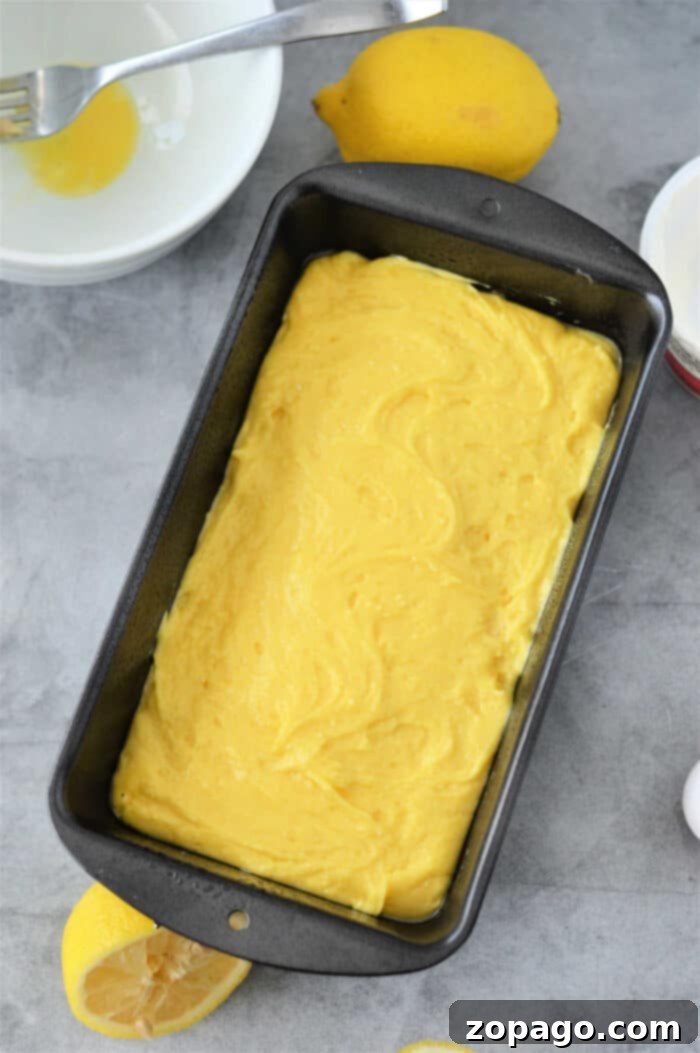 Homemade Lemon Pound Cake Recipe in a loaf pan, cooling.