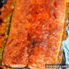 Close-up of a seasoned, baked Coho Salmon fillet on foil, showcasing a golden-brown crust in this delightful recipe.