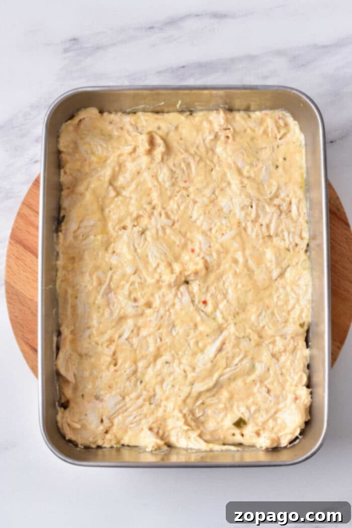 Spicy Creamy Buffalo Chicken Dip 4 A close-up of a bubbling Baked Buffalo Chicken Dip, fresh out of the oven, with melted cheese and a hint of buffalo sauce visible, ready to be served.