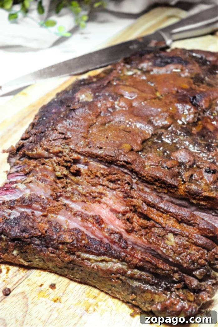 Mastering Roast Cooking Times 7 A perfectly smoked Brisket Flat, showing a beautiful bark and rich color, ready for slicing and serving.