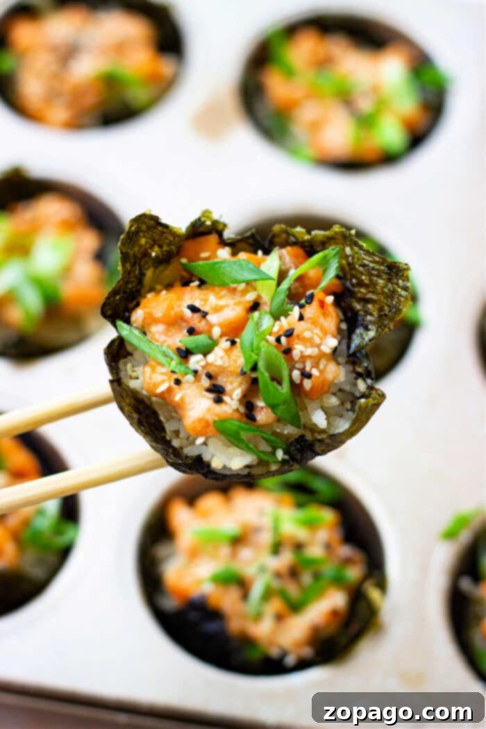 Mini Salmon Sushi Delights 2 Salmon Sushi Cups arranged beautifully in a muffin tin, ready to be served or baked.