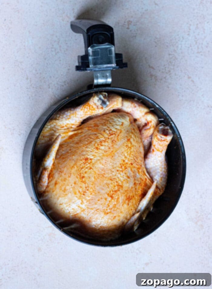 Air Fryer Whole Chicken From Frozen 7 A close-up of a cooked whole chicken from a frozen state, sliced and ready for serving, showcasing its juicy interior.