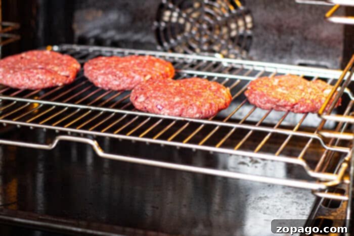 Hamburgers cooking on a rack in the oven