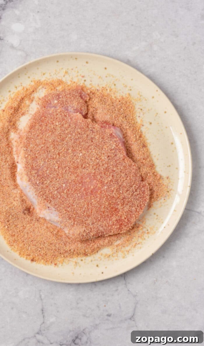 Thin Pork Chops in the Oven: Optimal Cooking Times 4 Beautifully oven-baked thin pork chops on a baking sheet, showcasing their golden crust.