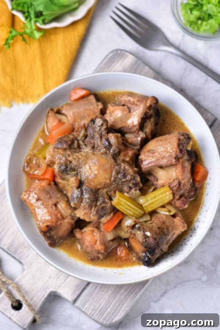 Slow-Cooked Oxtail Perfection 7 Braised Oxtail: A close-up of tender oxtail with vegetables, highlighting the rich gravy.