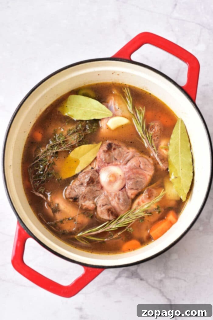 Slow-Cooked Oxtail Perfection 8 Dutch Oven Oxtails: Cooked oxtail pieces in a Dutch oven, surrounded by a flavorful sauce and vegetables.