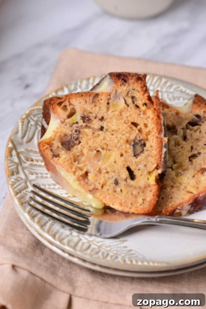 Perfect Fresh Apple Cake 6 A slice of Old Fashioned Apple Cake on a plate, showing its moist texture and apple chunks, ready to be enjoyed.
