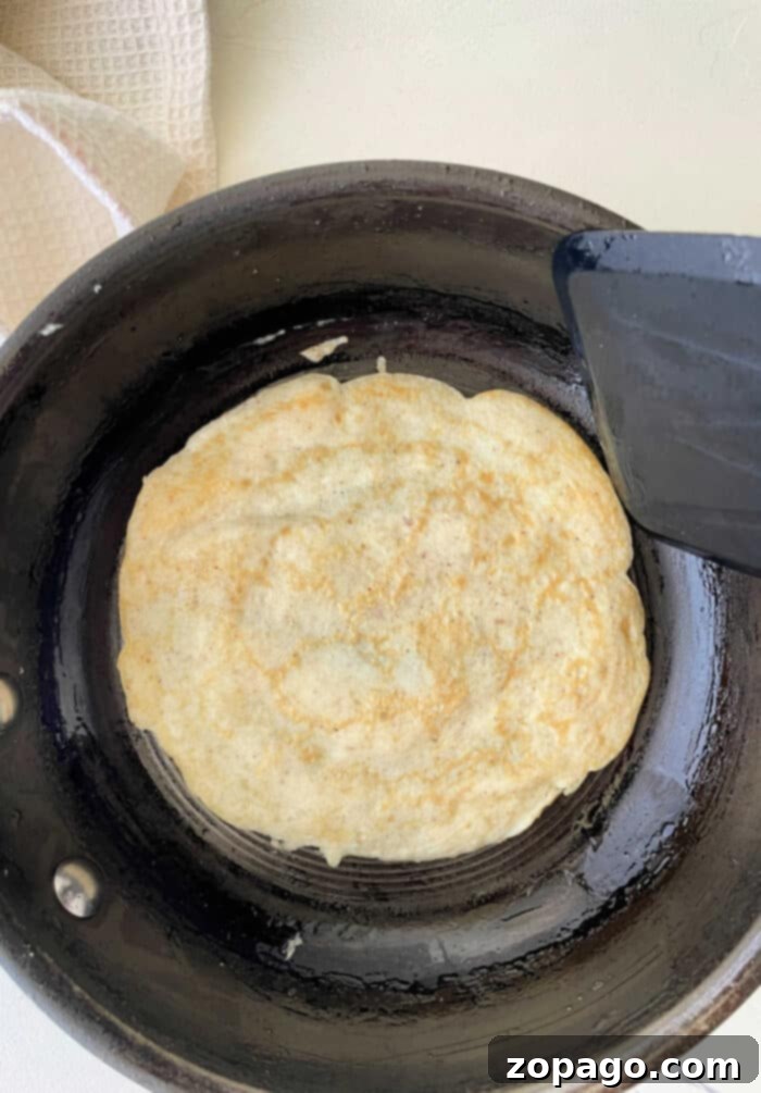 Protein Egg Wraps 4 A close-up of a delicate egg white tortilla wrap, folded and ready for filling, showcasing its flexibility.