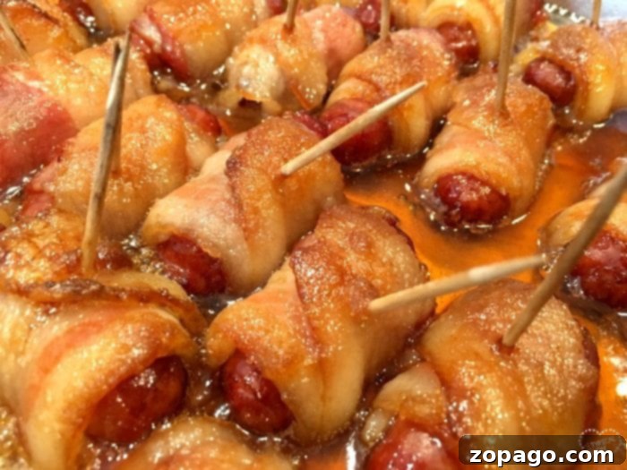 Irresistible Bacon Bites 7 Bacon-wrapped hot dogs with toothpicks, glazed in a sticky brown sugar sauce.