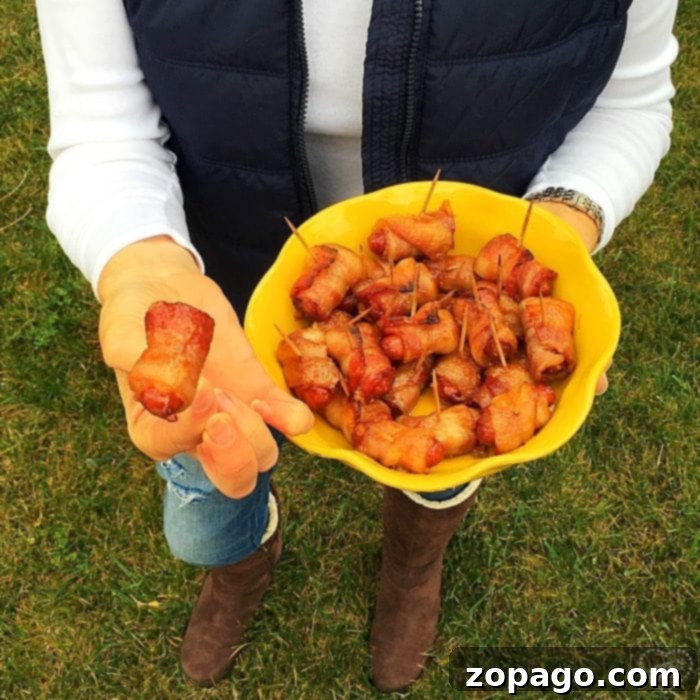 Irresistible Bacon Bites 8 A person holds a yellow bowl filled with tantalizing bacon-wrapped hot dogs with brown sugar, offering one of these irresistible snacks to tempt your taste buds.