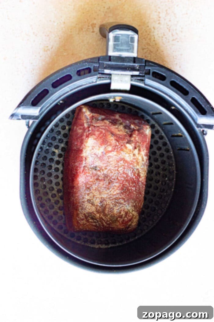 Crispy Air Fryer Frozen Roast 5 A Ninja Foodi air fryer with a frozen roast inside, showcasing how easy it is to cook from frozen.